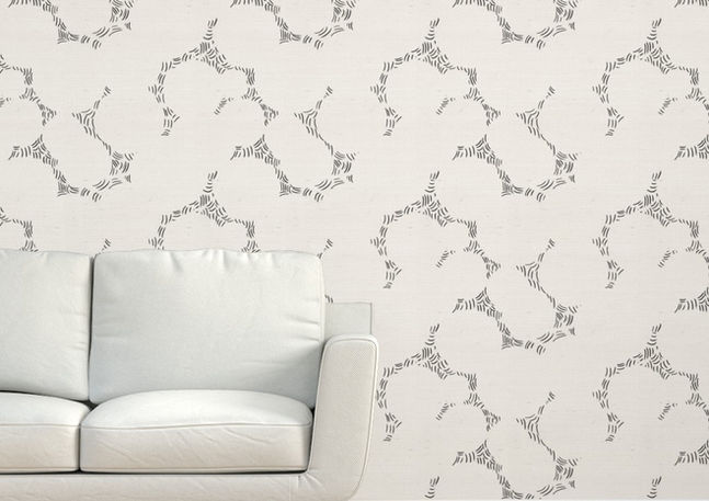 A slightly creased piece of fabric showing a design of intersecting ornamental circles framed by scattered stitches.