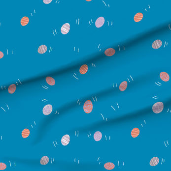 A slightly creased piece of fabric featuring tossed small decorated easter eggs.