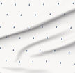 A slightly creased piece of fabric featuring small blue raindrops on a white field by lenes_linien.