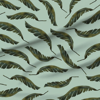 A slightly creased piece of fabric featuring the described banana leaf design by lenes_linien.