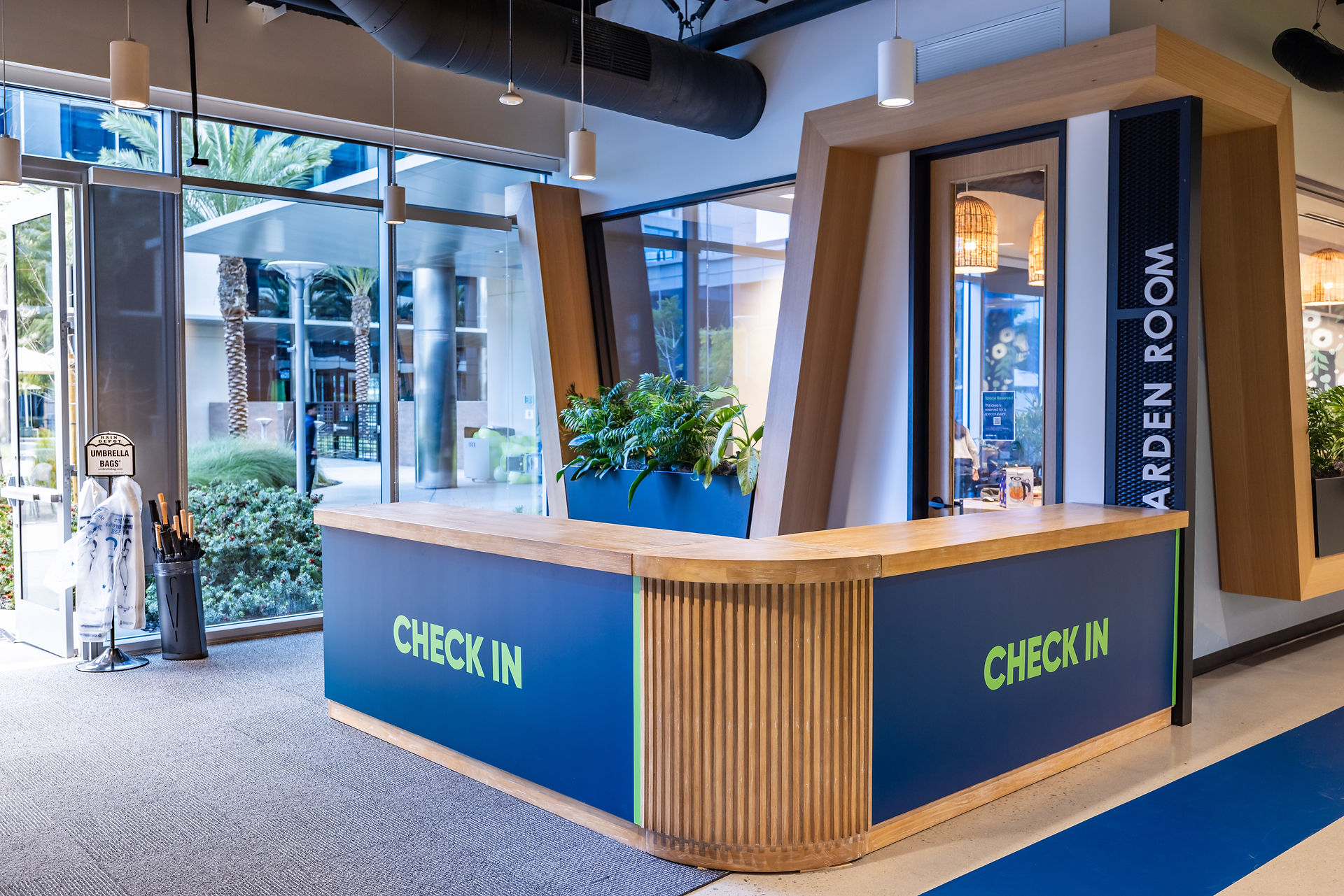Corporate event check-in desk with modern branding and natural accents.