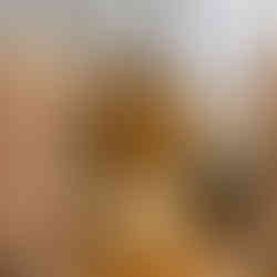 Gold accent table and neutral seating in an elegant cocktail lounge arrangement.