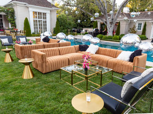 Outdoor lounge seating with gold accents for sophisticated sunset event design