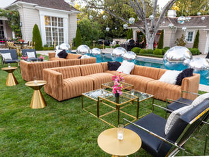 Outdoor lounge seating with gold accents for sophisticated sunset event design