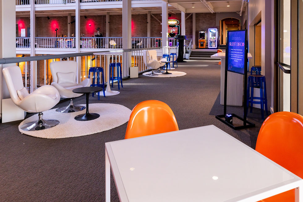 Experiential event design networking area with modern chairs, high tables, neon lighting and interactive layout