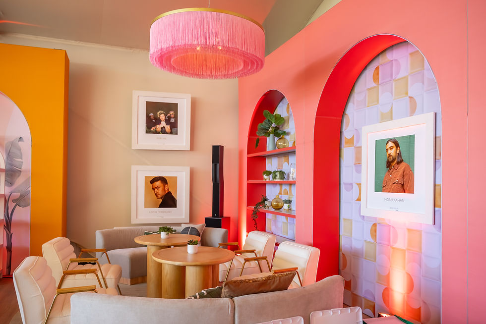 Retro lounge with framed portraits and stylish furniture in a custom event design setup.
