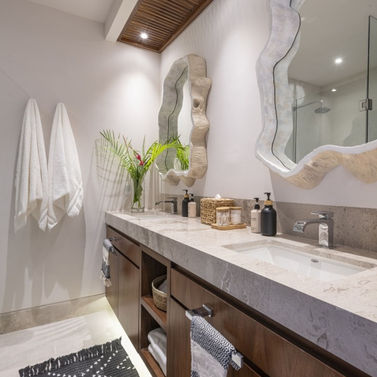 Double sink bathroom with light coastal-inspired decor and serene, relaxing ambiance.