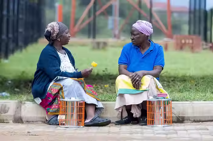 Two women with their new cookstoves in South Africa. Source: TASC