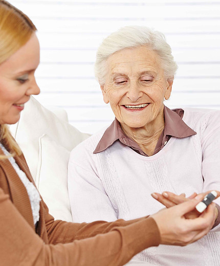Pharmacist helping elderly woman