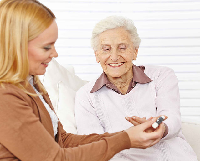 Pharmacist helping elderly woman