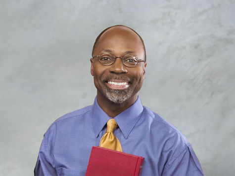 A black pastor smiling.