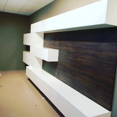 White shelves on a wood-paneled wall, modern interior design HOME.