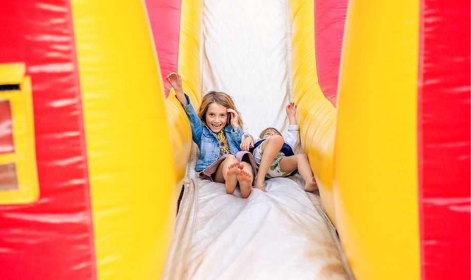 Kids sliding on a giant inflatable slide