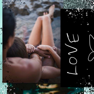 Couple embracing with text LOVE; romantic moment shared on the beach.