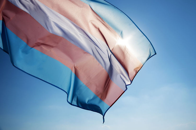 transgender-pride-flag-waving-on-the-blue-sky-royalty-free-image-1695856611.jpg