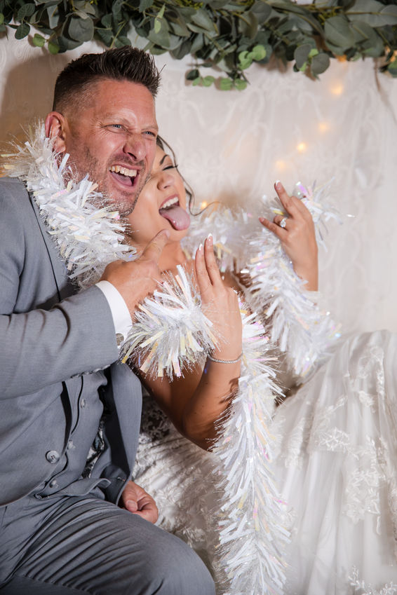 Candid portrait of bride and groom in a photo booth at Pageo Lavendar Farm in Turlock, CA.