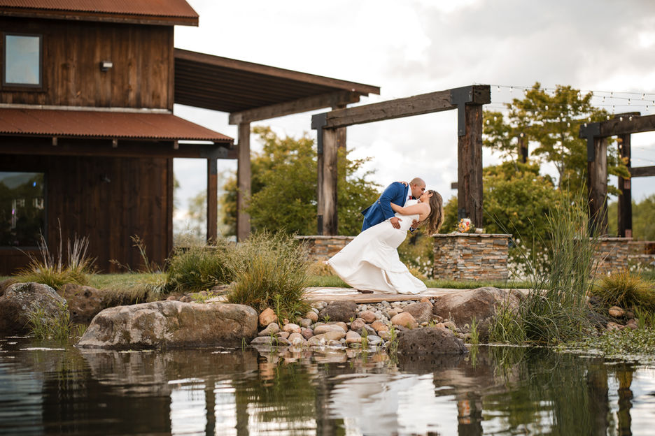Portrait of a bride and groom in a passionate dip and kiss at Quincy Lake Farm in Oakdale, CA