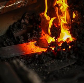 Silas Wolff heats up some steel at his Kennebunkport workshop.