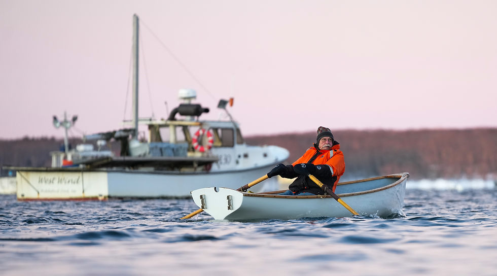 Peter McPheeters rows past lobster boat West Wind in Biddeford Pool on February 22, 2025.