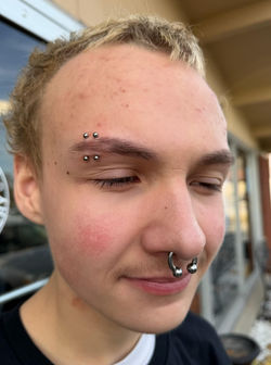 Double eyebrow piercing by Joshua Burns, titanium jewelry by Anatometal