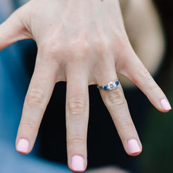 Colourless Moissanite and Cornflower Blue Sapphire 3 stone Engagement Ring in Platinum