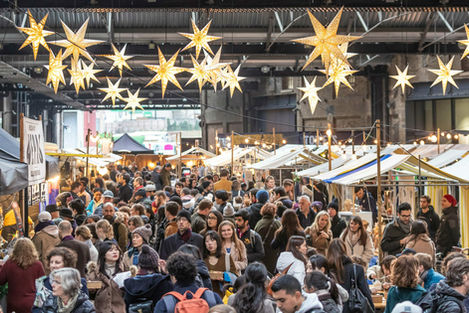 Crowds in West Handyside Canopy King's Cross, visiting a Christmas Canopy Market