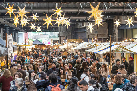 Crowds in West Handyside Canopy King's Cross, visiting a Christmas Canopy Market