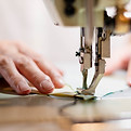 vecteezy_closeup-the-female-hand-use-sewing-machine-and-cotton-fabric_18922559.jpg