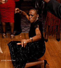 Nigerian wedding DJ, Lady in black dress dancing, Nigerian DJ near me. Click to visit djblinkblink.c