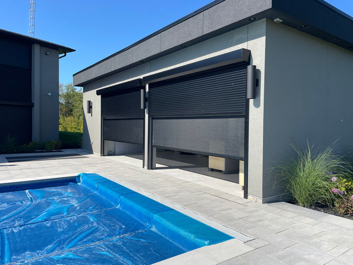Modern outdoor room with integrated Sunrise screens and shutters in a custom residential setting