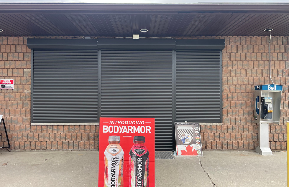 Closed roller shutters on a commercial storefront in Ontario, Canada