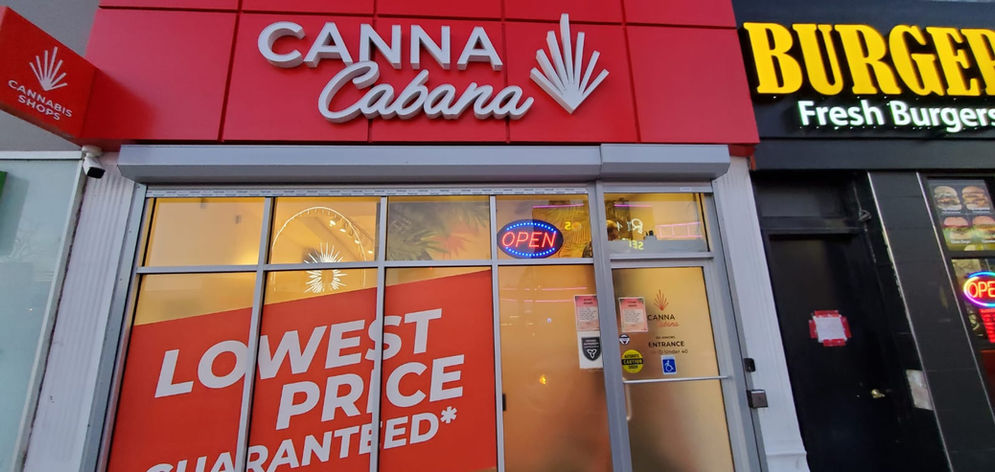 Cannabis retail storefront with open display window and roll shutter housing above the storefront