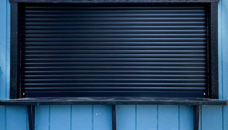 Close-up of custom-built roll up shed doors demonstrating its security features in Cambridge