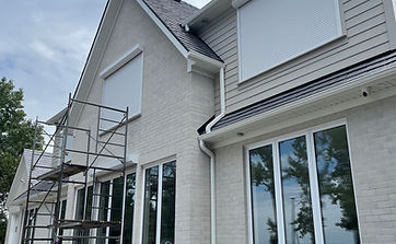 Beachfront cottage on Lake Huron with eight lakefront-facing windows fitted with exterior roll shutters for wind, rain, and winter weather protection