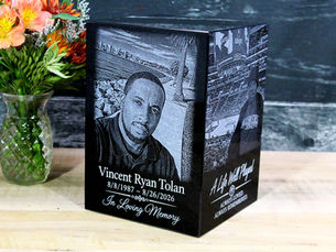Photo-etched black granite cube earn tells life story