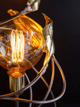 a spiral brass leaf lamp by Niv Shafran