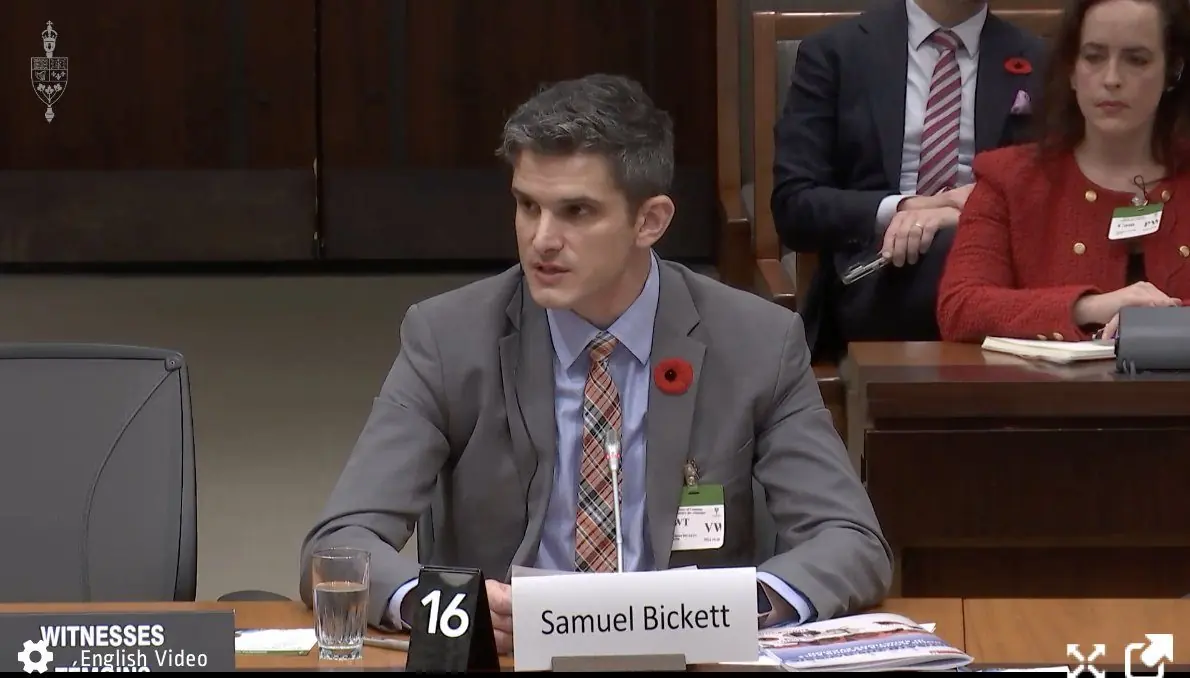 Samuel Bickett testifying before a parliamentary committee