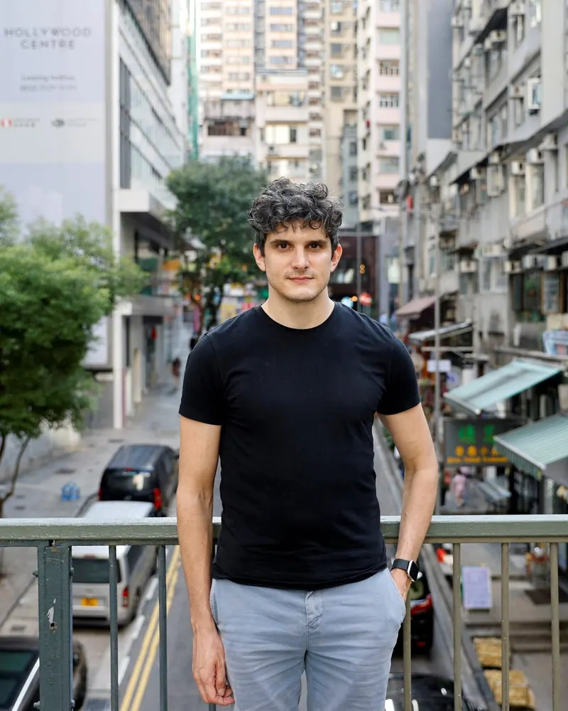 Samuel Bickett on a footbridge in Hong Kong