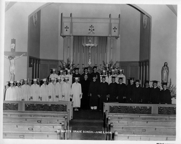 Black-and-white St. Mary’s Grade School graduation group poses in a church before the altar; text reads June 3, 1956.