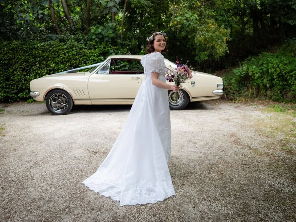 Classic bridal portrait. In the driveway with classic car in the background