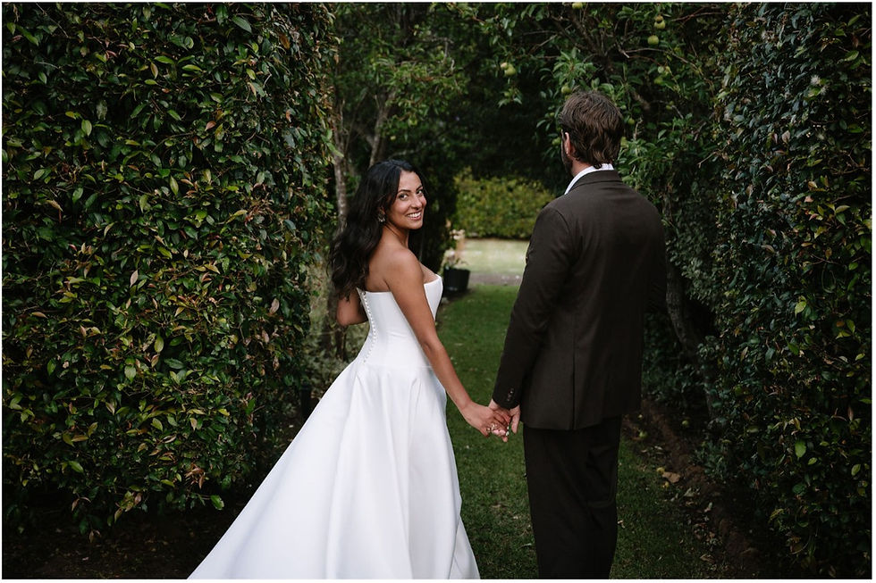 ride wearing KYHA Aspen Bright Ivory duchess satin drop waist wedding gown with side split