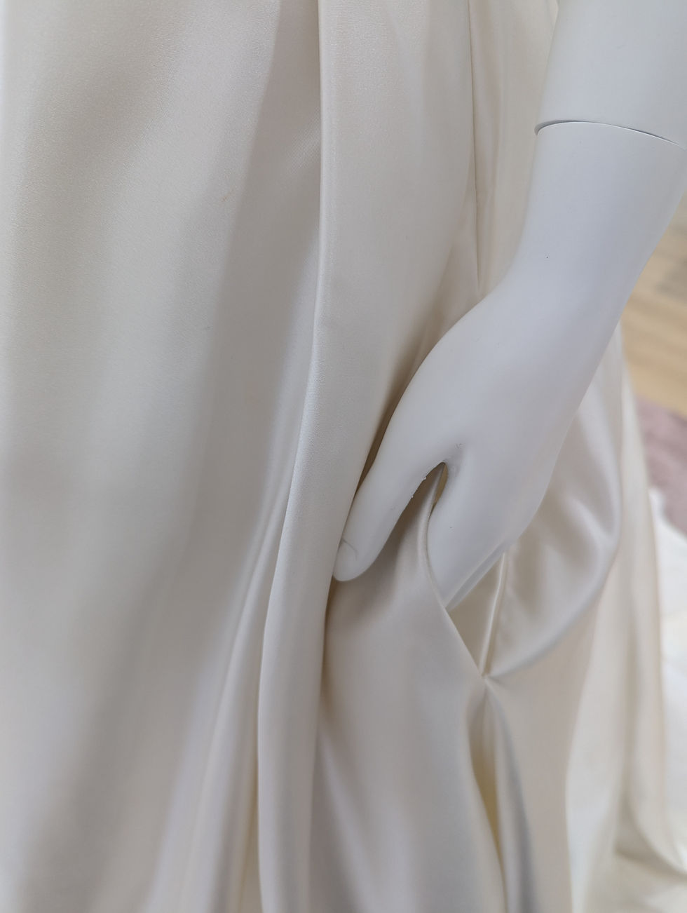 Thumbnail: Rebecca Ingram Sammie Satin ballgown with pockets, pictured on mannequin, detail photo of pocket with mannequin hand