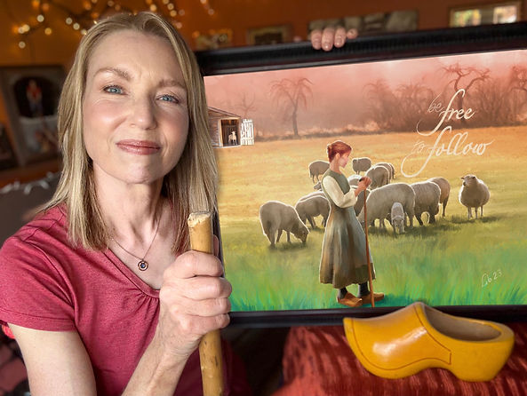 Cassandra Uncaged Coach Libby Clark holding a painting she painted that inspires her coaching