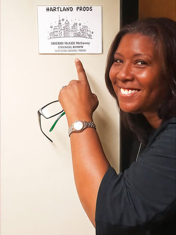 Writer Sherri McGee McCovey points to a sign outside the writers room