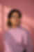 Woman in lavender sweatshirt against a pink background