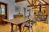 Rustic dining room with wooden table and chairs.