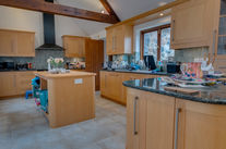 Modern kitchen with wooden cabinets and island counter.