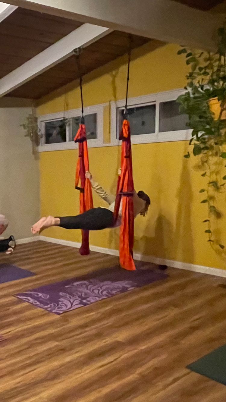 Doing a trapeze yoga pose