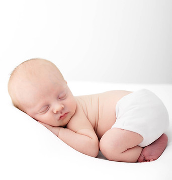 Newborn baby sleeping on stomach.