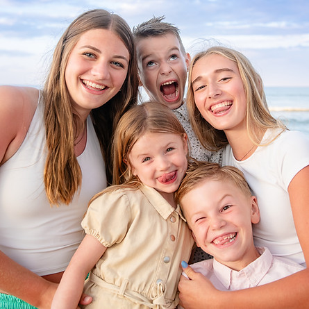 Fun photos with the kids on the beach during vacation making silly faces! family vacation beach photographer, outer banks